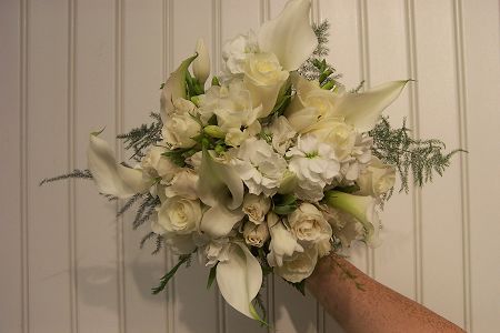 Gorgeous white calla lilies mixed with white roses wedding bouquet is a 
