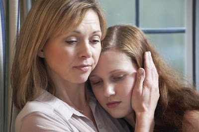 Mother comforting daughter