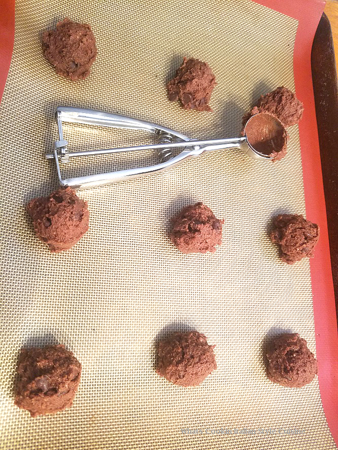 raw chocolate ricotta cookies dropped on a silpat mat