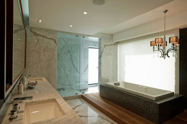 Modern bathroom with white marble walls and bath tub