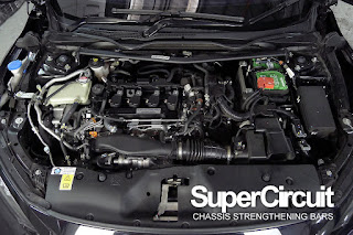 The engine bay of the 10th generation Honda Civic FC 1.5 Turbo with SUPERCIRCUIT downpipe installed.