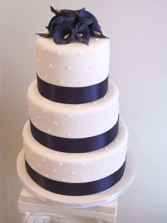 Next comes another purple cake wrapped with purple ribbons and topped with