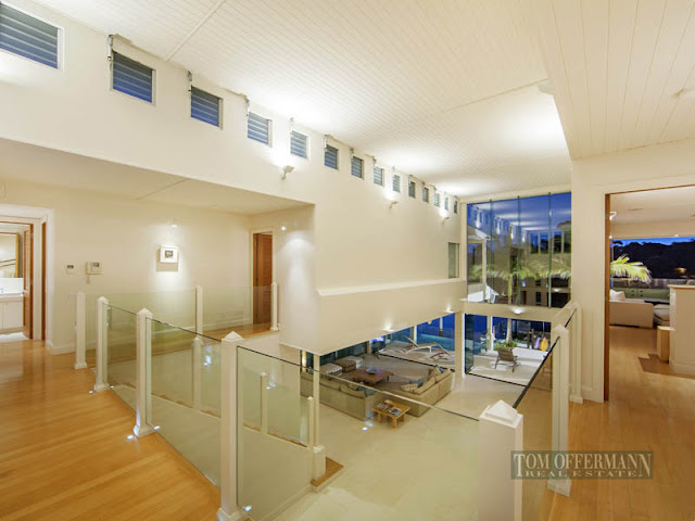 Photo of house interiors as seen from the interior balcony inside of amazing waterfront home
