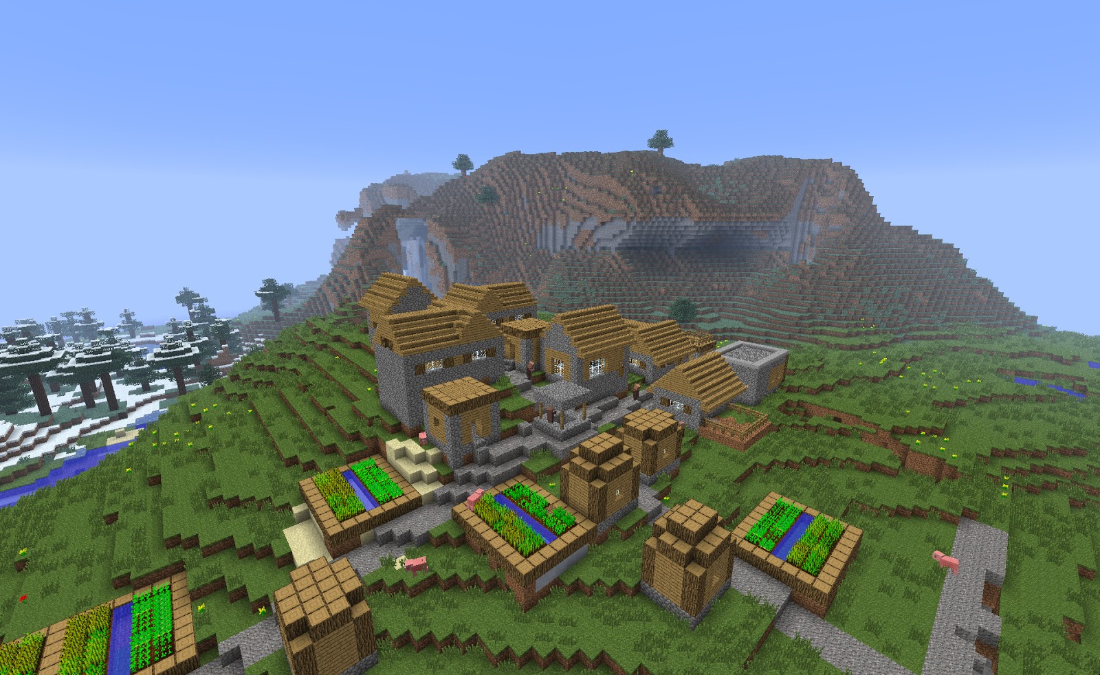 ... NPC village at spawn in front of some epic hills and a jungle biome