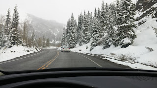 driving on the snow-capped Million Dollar Highway in May from Telluride to Durango Colorado
