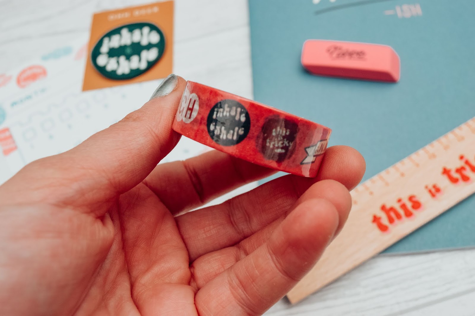 A roll of red washi tape with various quotes