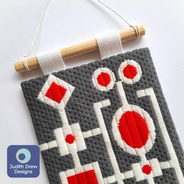 Judith Drew Designs Abstract geometric design tapestry wall hanging in grey, white and red Appletons wools.