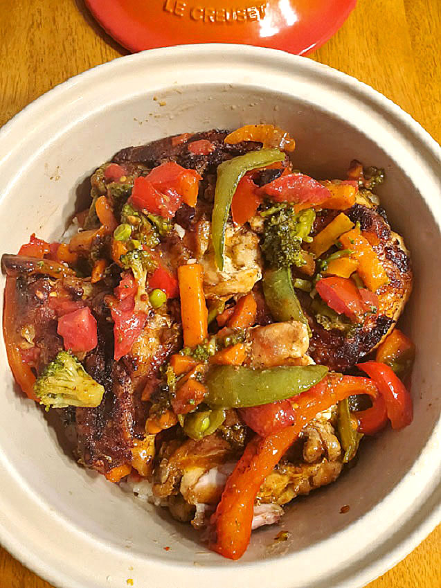 chicken and vegetables over fluffy white rice