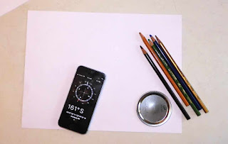 A picture of a phone with a compass app.