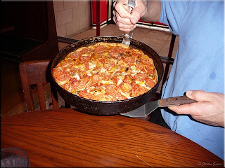 Gino serves the pizza