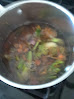 Pot on stove with vegetables making broth.