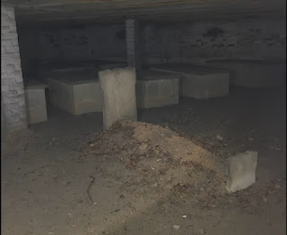 Family Cemetery under a building with a different grave stone for a girl from another state who died after jumping out of a window © Photo by HW