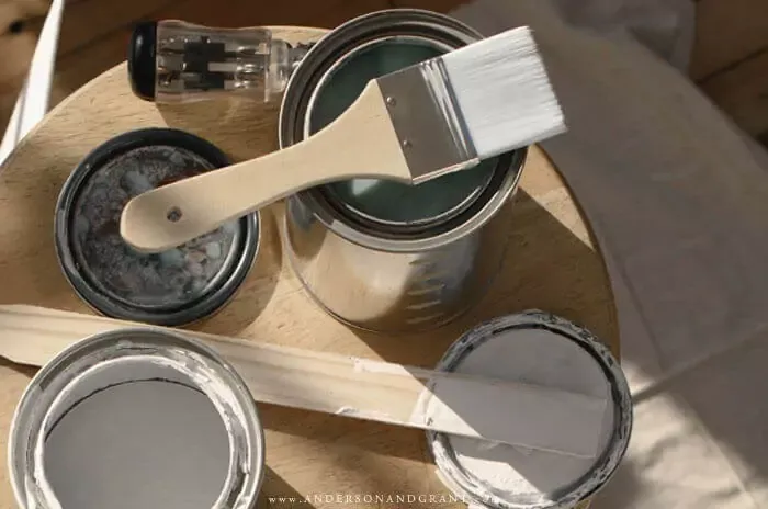 Open cans of paint and brushes