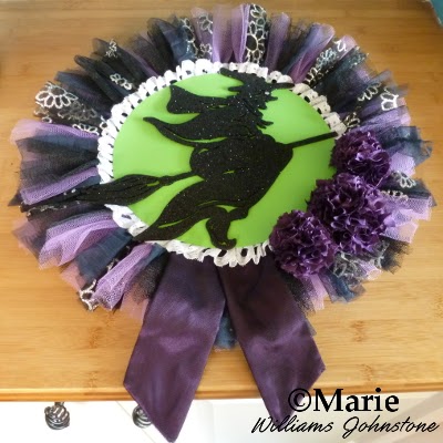 Black and purple Halloween witch wreath made with tulle and pom poms