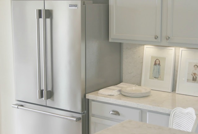 Serene chic simple Nordic French kitchen with grey cabinets and Soprano quartz countertop and backsplash