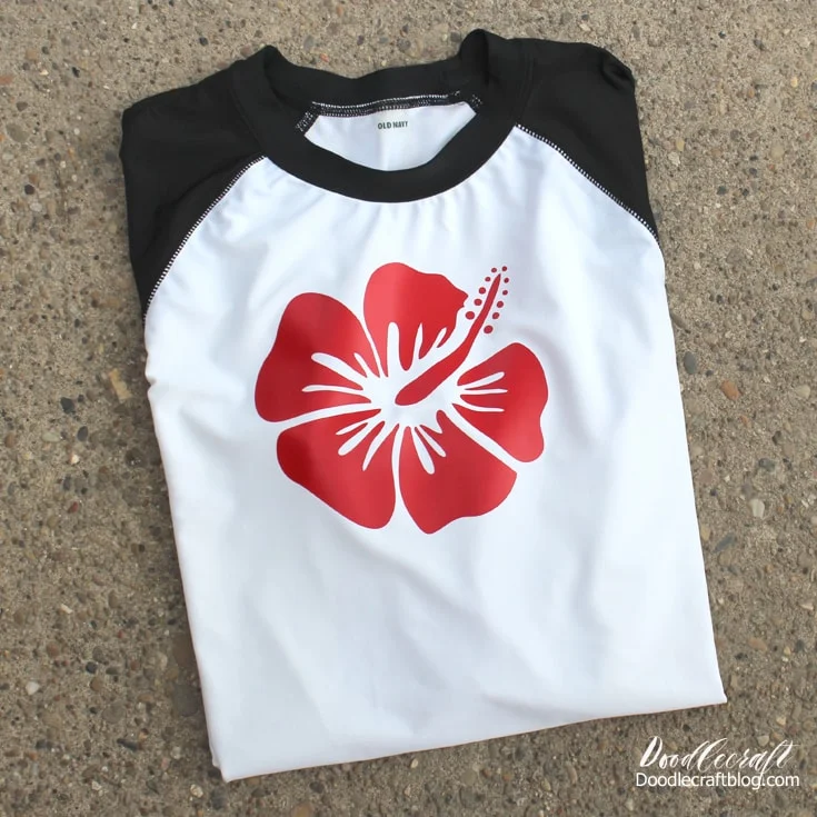 White rashguard with black sleeves decorated with red sportflex iron on vinyl with tropical hibiscus flower.
