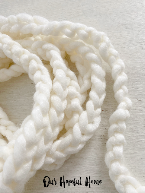 white chunky knit chains coiled on table