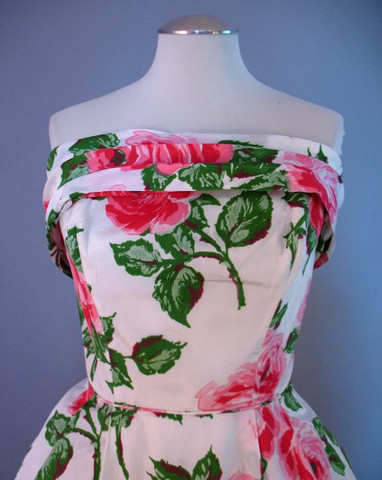 The strapless bodice of this 1960s rose printed evening gown is decorated 