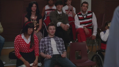 Tina as Rachel next to Kurt as Finn, he has a dopey smile on his face much the way Corey portrays Finn