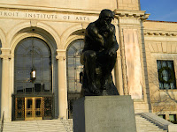 statue of The Thinker in front of the Detroit Institute of Arts