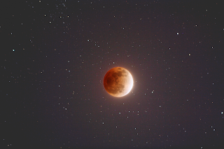 In total lunar eclipse the colour of the moon is red .