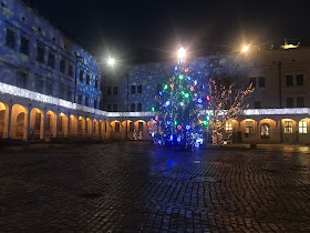 christmas tree and snowflake projections on the side of a castle