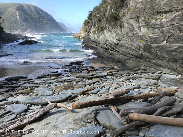 Boulders and wood on Drift Wood Beach in the Tsitsikamma National Park in South Africa.