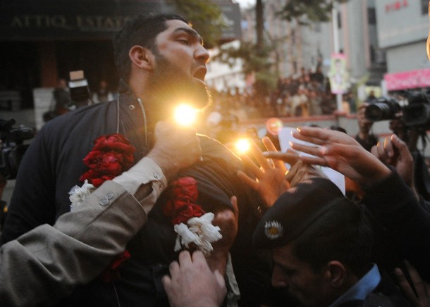 Arrested Pakistani bodyguard Malik Mumtaz Hussain Qadri wearing a garland