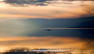 A lone kayaker on the glassy reflections of Lake Okanagan in the late fall, by Chris Gardiner Photography www.cgardiner.ca