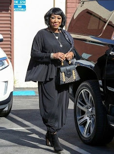Patti LaBelle posing for the picture wth the car