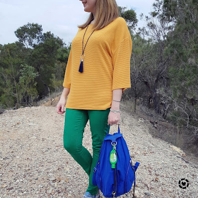 awayfromtheblue Instagram | Kmart short sleeve textured dolman top in marigold with green skinny jeans and bright blue backpack