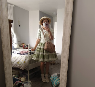 I am standing in front of my mirror showing my full coordinate. I have a green cutsew ontop of a green JSK with oldschool lace. I am wearing a boater hat, ankle socks and white heels.