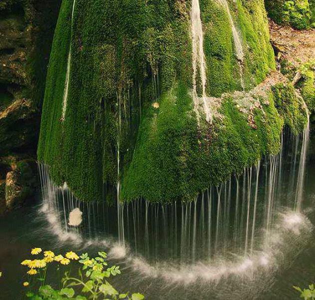 Beautiful unique waterfall in a forest in Romania