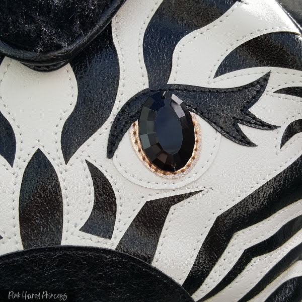 zebra stripes and jewel eye on front of Irregular Choice handbag