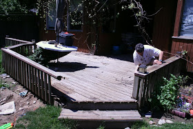 Hubby measuring something (or maybe just pulling the nails off?!) :: The Deck Odyssey (All Pretty Things)
