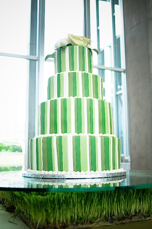 Amazing six tier wedding cake in a lovely green with tiny pink flowers