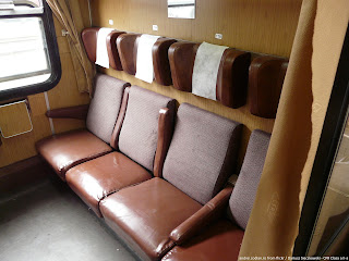 Photo of Old Style CFR or Romanian Railways typical Second Class compartment, showing 4 brown vinyl seats facing another 4