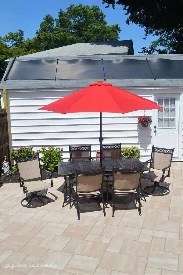 Cambridge Pavers Ledgestone XL with cast aluminum patio set and red umbrella