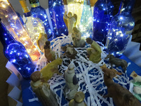 creche with lighted bottles