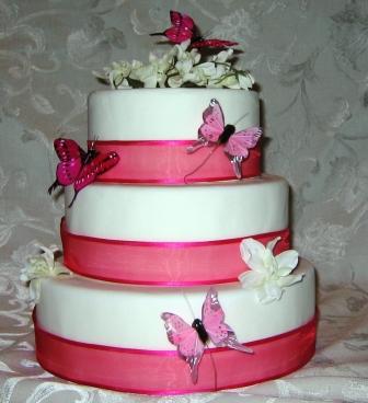Three tier pink wedding cake with butterflies and beads