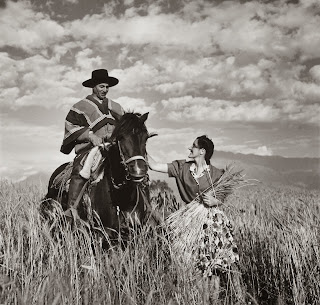 Señora Maria Vial de Prieto petting gaucho's horse Prique, in a wheat field in Chile | Library of Congress