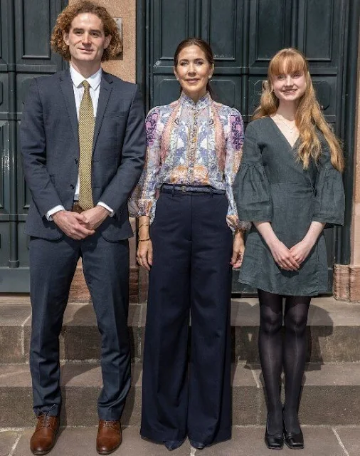 Crown Princess Mary wore a new kaleidoscope button multi swirl floral blouse by Zimmermann. Navy blue wide leg trousers