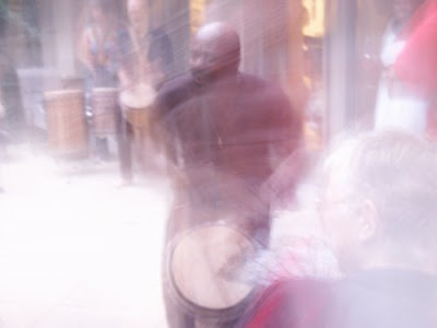 man playing djembe