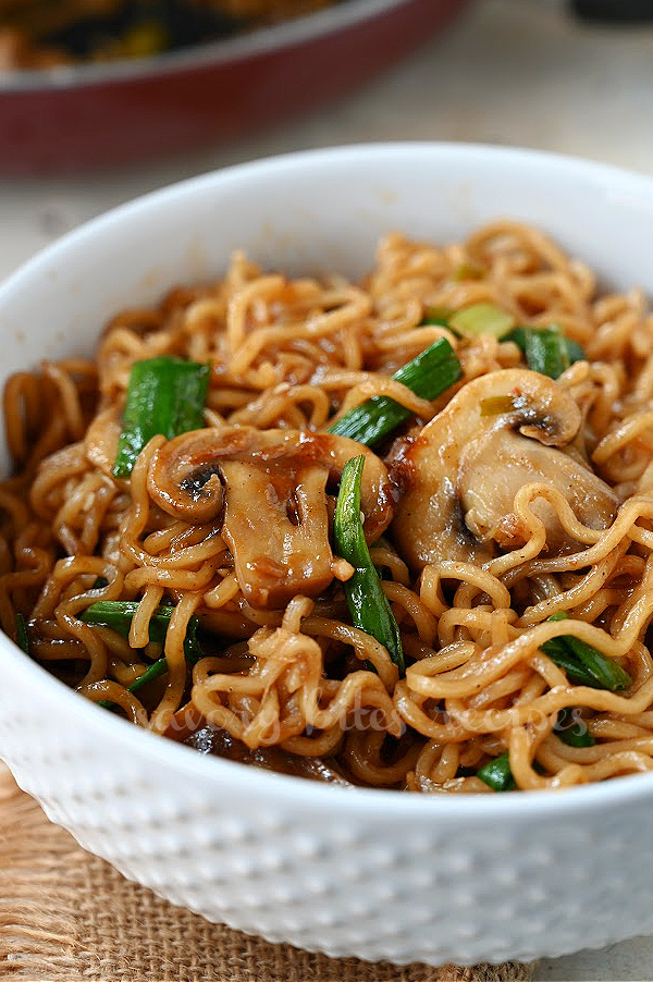 a white bowl with mushroom ramen