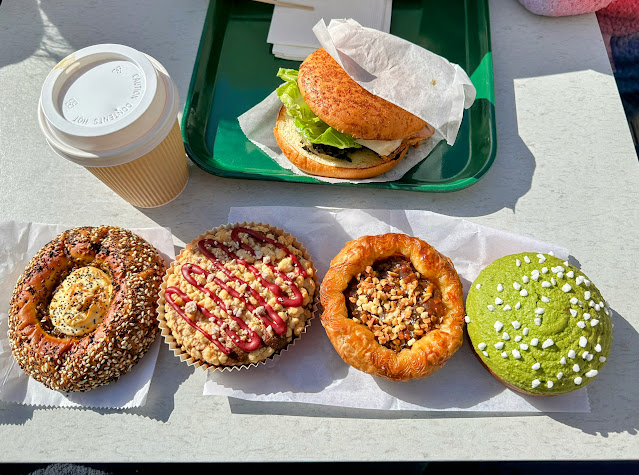 4 pastries, a sandwich and coffee on a table at San Francisco's Bread Belly