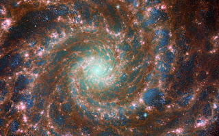 M74 - combined optical/mid-infrared image, featuring data from both the NASA/ESA Hubble Space Telescope and the NASA/ESA/CSA James Webb Space Telescope.