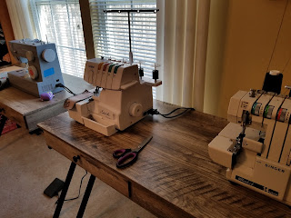 Three sewing machines taken from an angle.