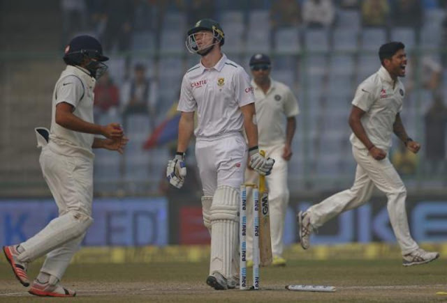 South Africa's Dane Vilas, center, walks back after being bowled by Umesh Yadav. (AP)