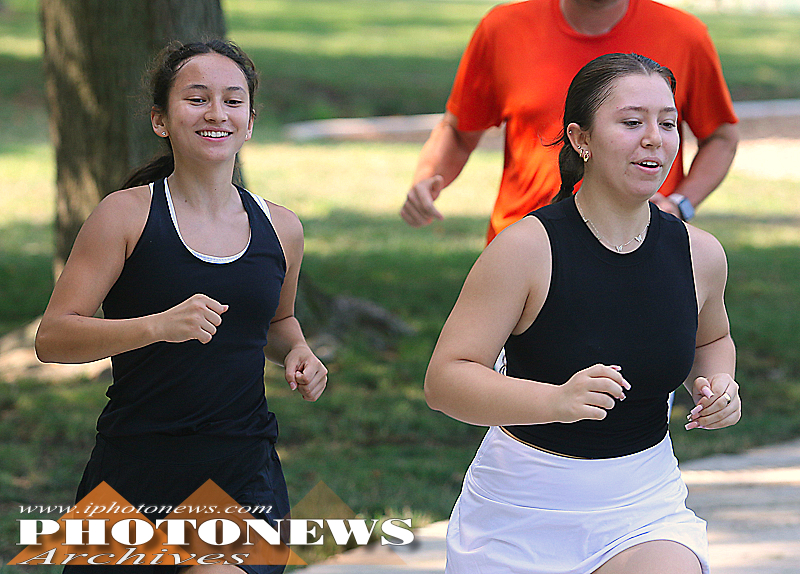 Luna Morales and Lorelei Yau run during tennis practice