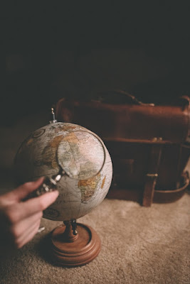 Photo of a globe with a magnifying glass